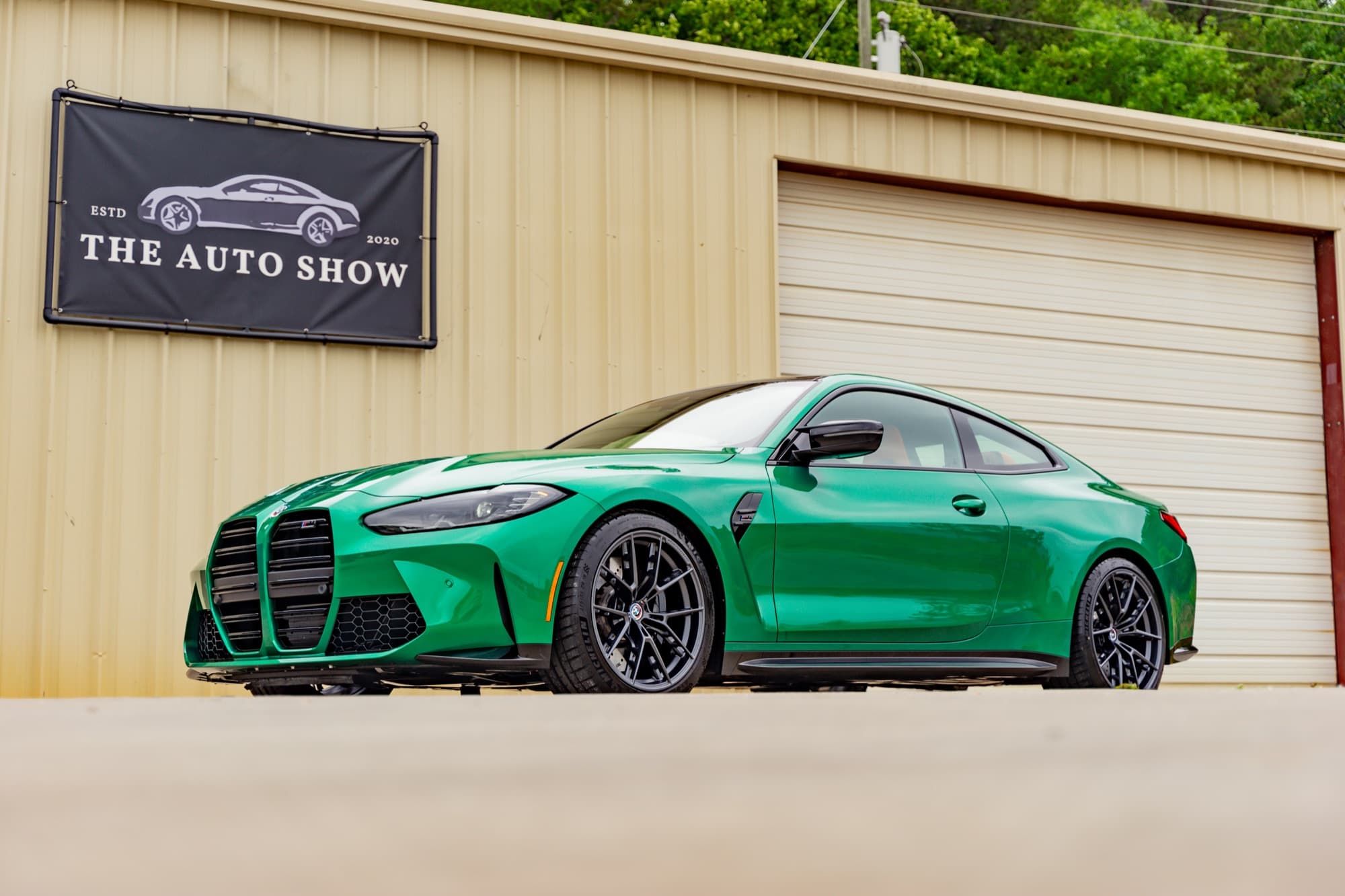 Green BMW M4 parked outside The Auto Show