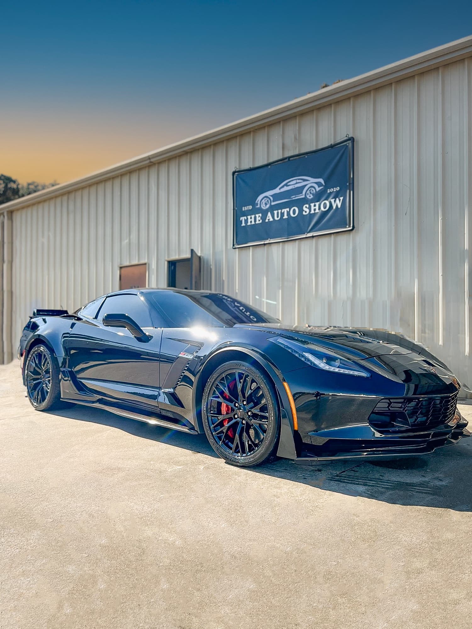 Black Chevrolet Corvette outside the shop