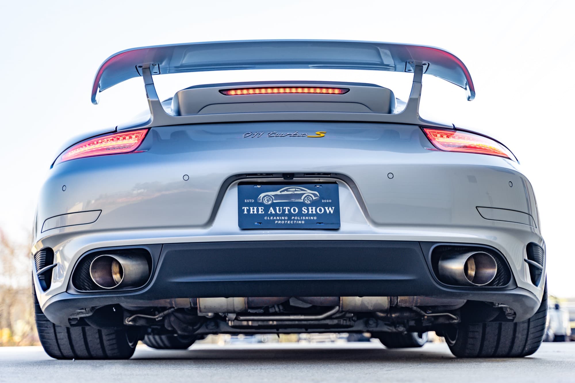 Rear three-quarter view of a glossy Porsche 911 Turbo S