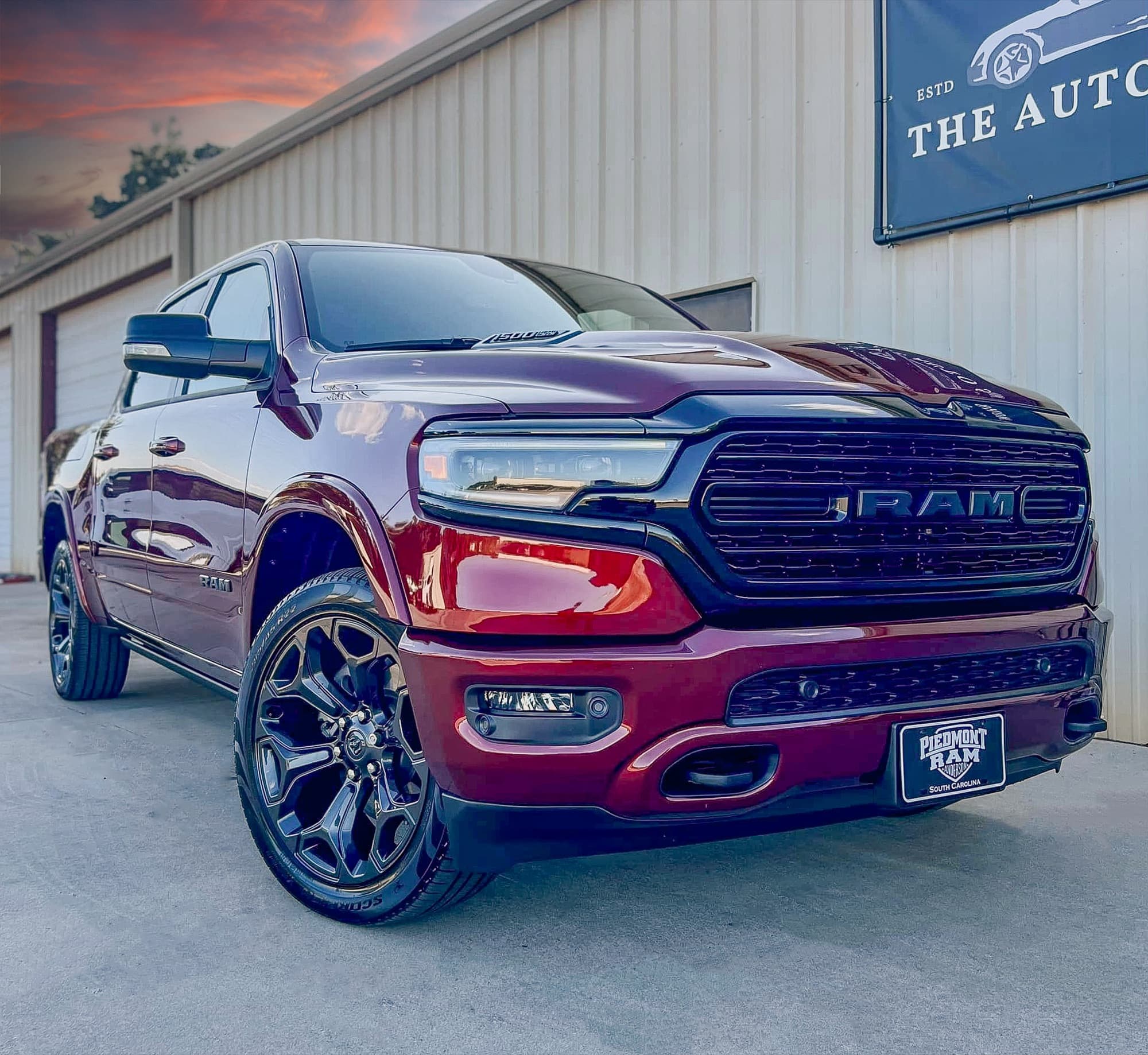 A dark red Ram 1500 pickup parked outside The Auto Show