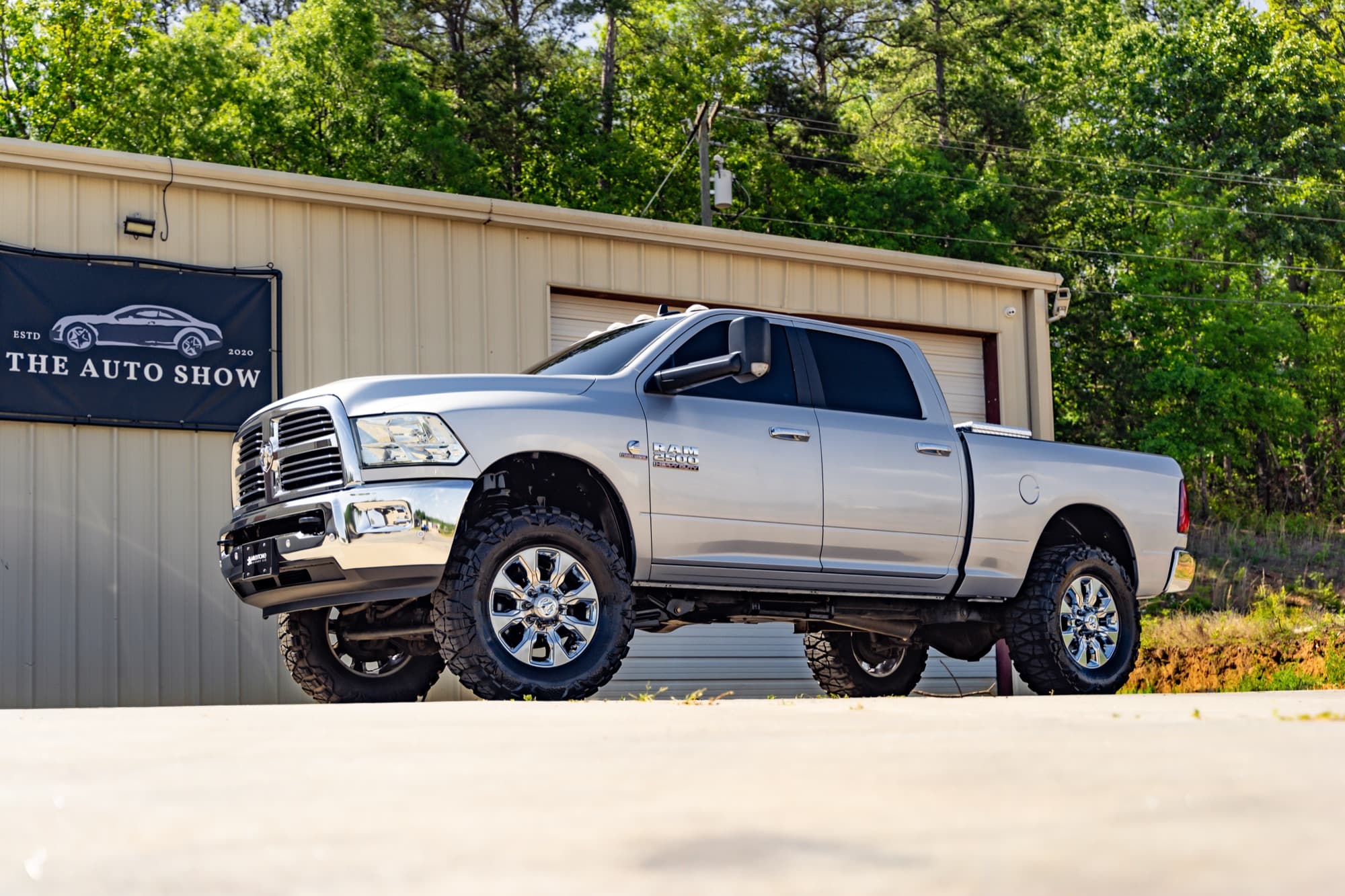 Silver Ram 2500 pickup on a lifted suspension parked at The Auto Show