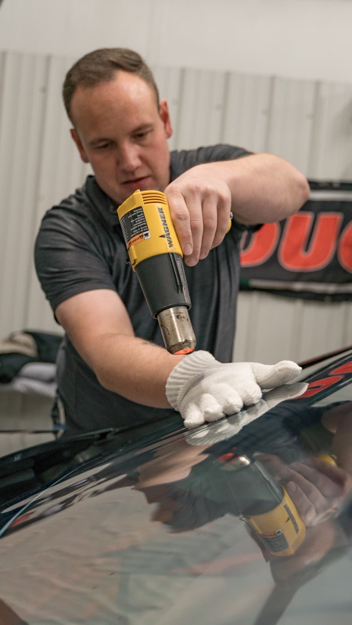 Installer heat-forming window film with a heat gun